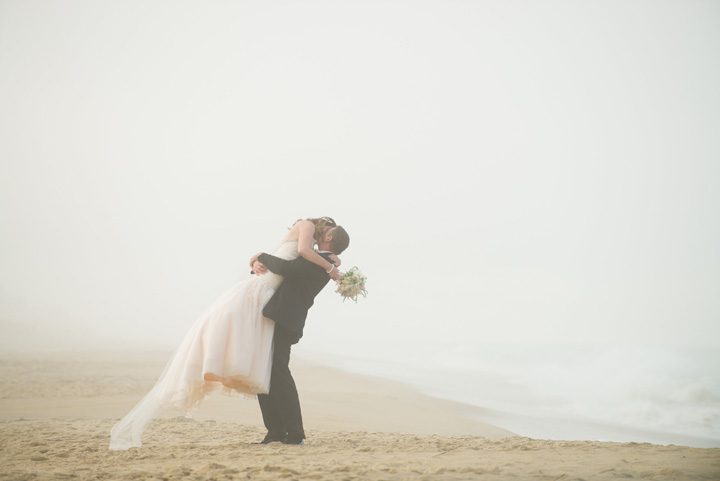 Michelle and Will Outer Banks wedding photographer Jennette's Pier beach kiss