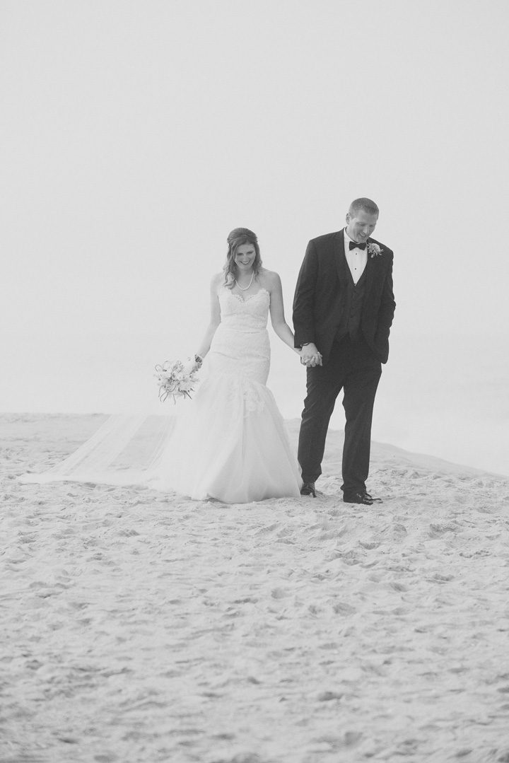 Michelle and Will Outer Banks wedding photographer Jennette's Pier bw portrait walking