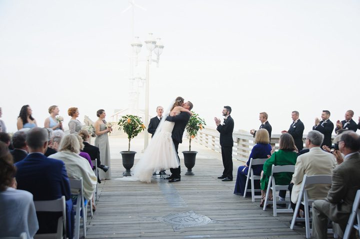 Michelle and Will Outer Banks wedding photographer Jennette's Pier first kiss