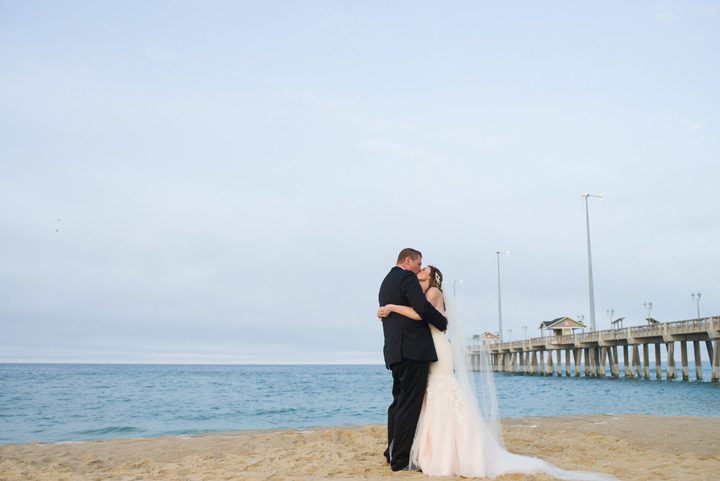 Michelle and Will Outer Banks wedding photographer Jennette's Pier pier behind