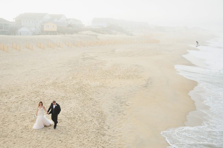 Michelle and Will Outer Banks wedding photographer Jennette's Pier portrait walk away