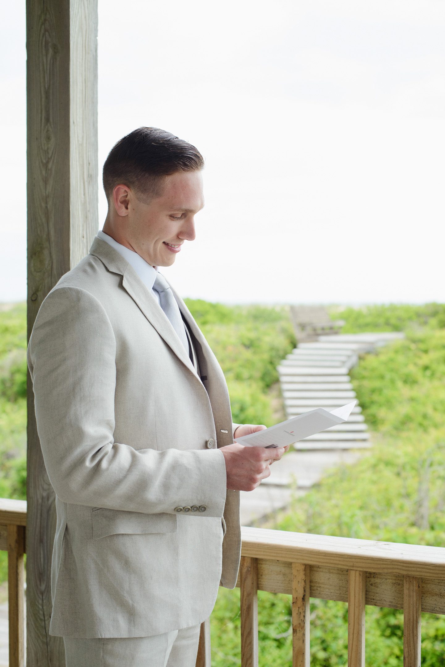 Outer Banks Wedding Photographers Neil GT Photography Palmers Island Beach Elopement Groom Reading Card