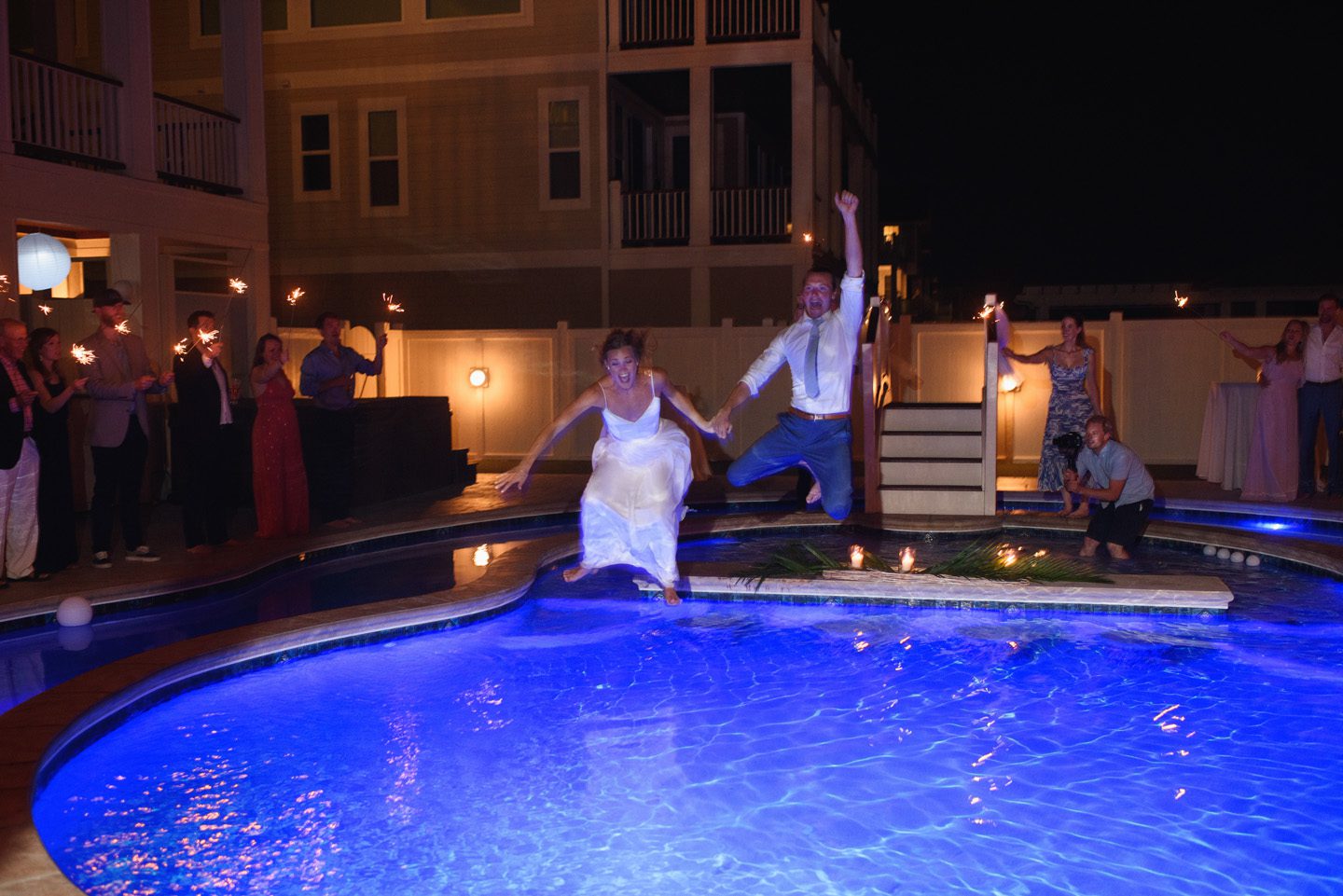 Bride and Groom Jump into Pool Photographer at Moonlight Wedding Photography Portraits at Sunset Wedding Portrait Photography at Outer Banks Wedding at Sound to Sea Beach Club