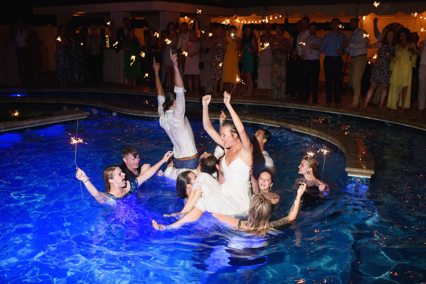 Bride and Groom Jump into Pool Photographer at Moonlight Wedding Photography Portraits at Sunset Wedding Portrait Photography at Outer Banks Wedding at Sound to Sea Beach Club