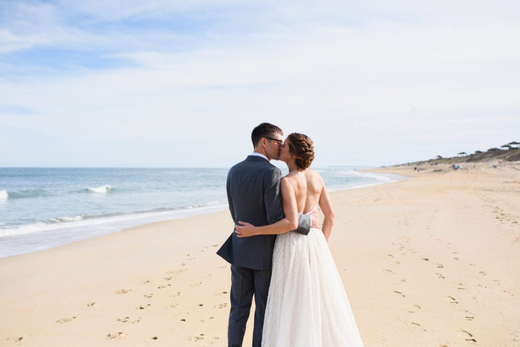 Bride and groom walk away together on the Outer Banks