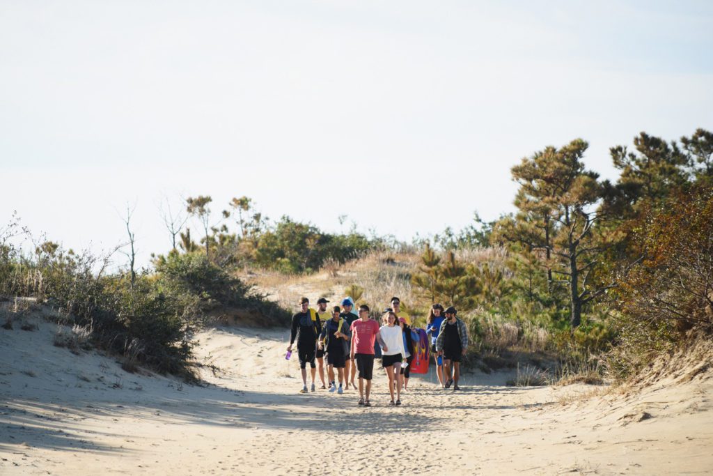Friends walking to play frisbee at Jockey's Ridge state park