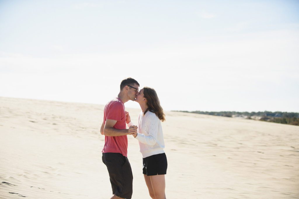 Couple kiss on the dunes at Jockey's Ridge State Park