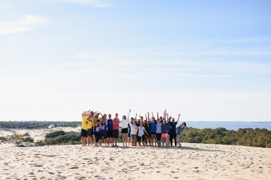 Group of friends at Jockey's Ridge on a wedding day