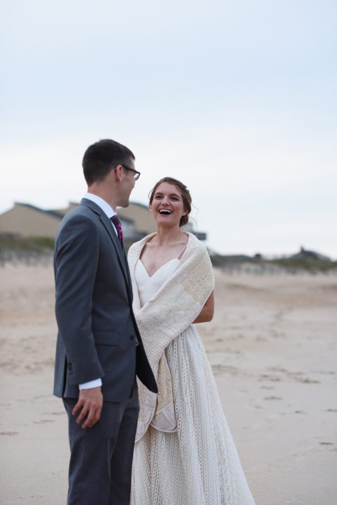 bride and groom on the beach at sunset