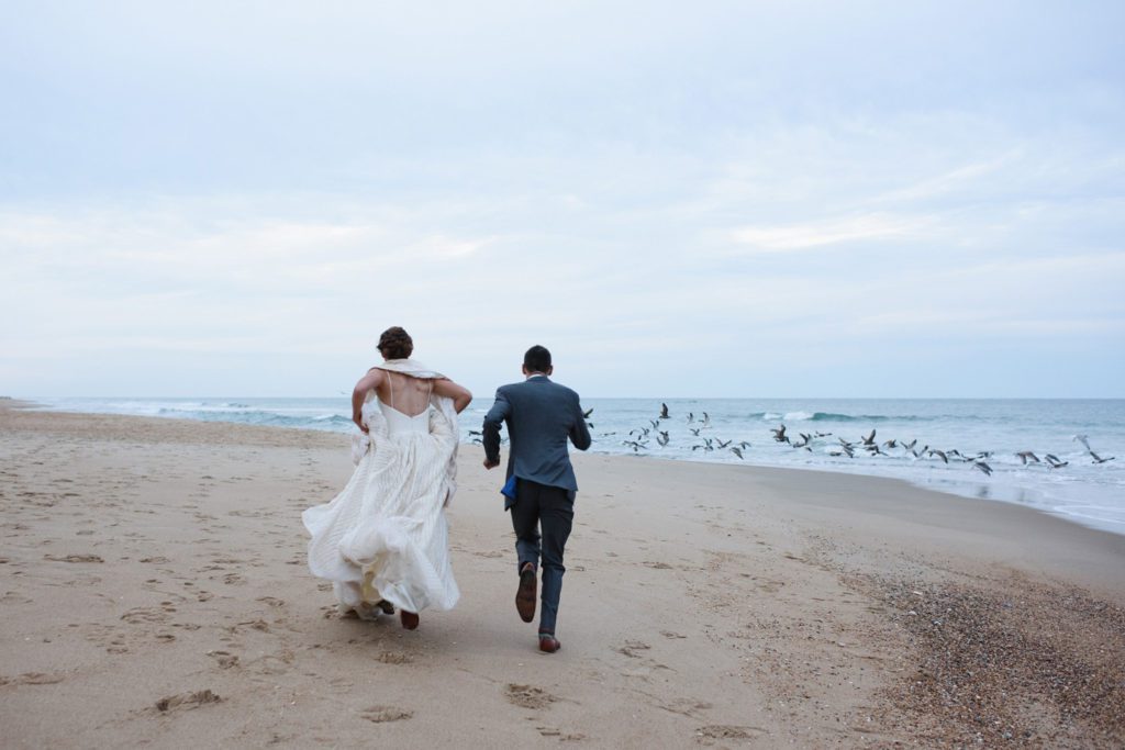 Running away on the beach at sunset