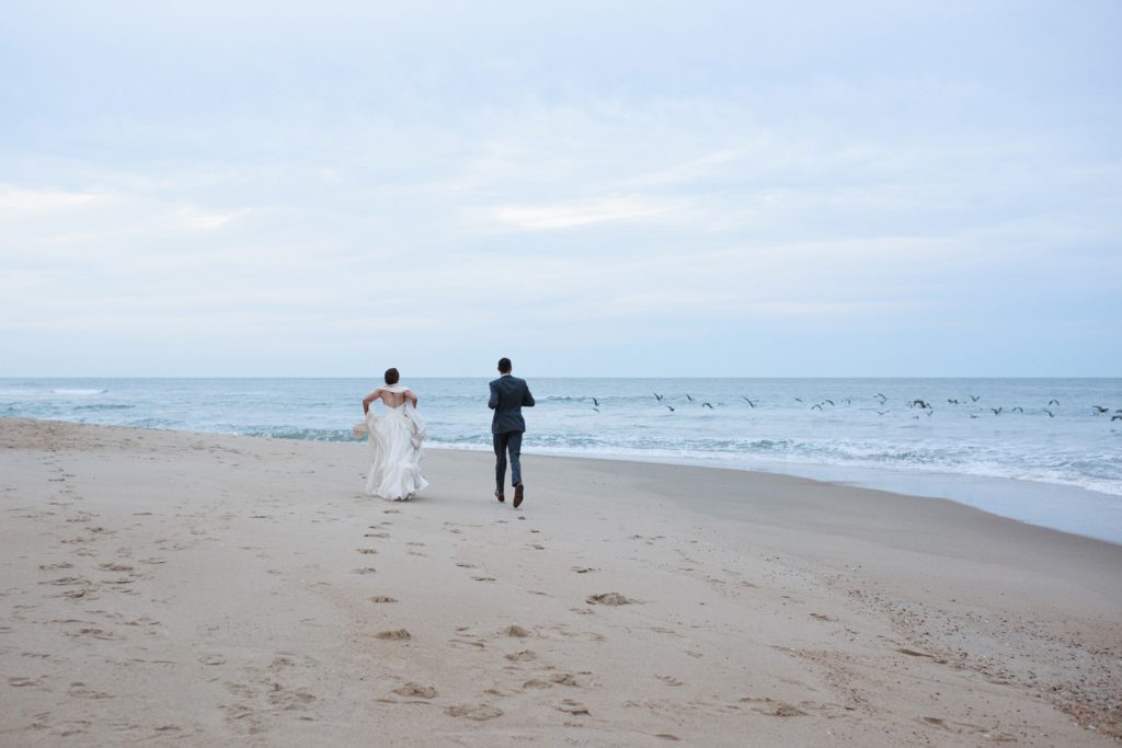 Bride and groom on the beach at sunset