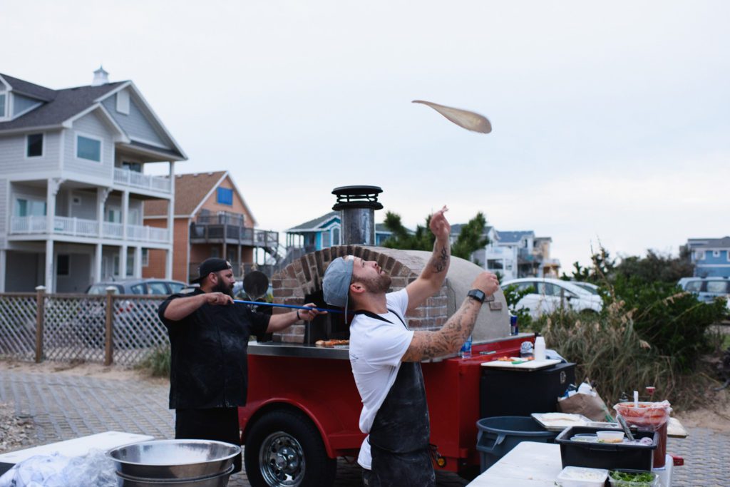Cosmos Pizza catering Throwing dough on the Outer Banks