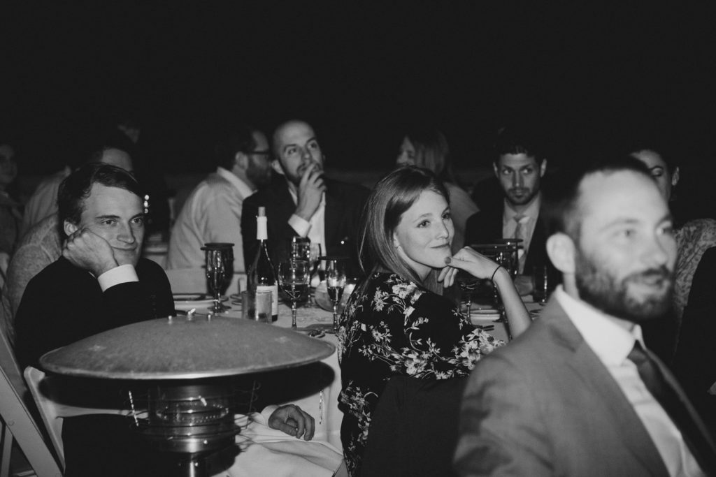 Emotional wedding guests listen to speeches