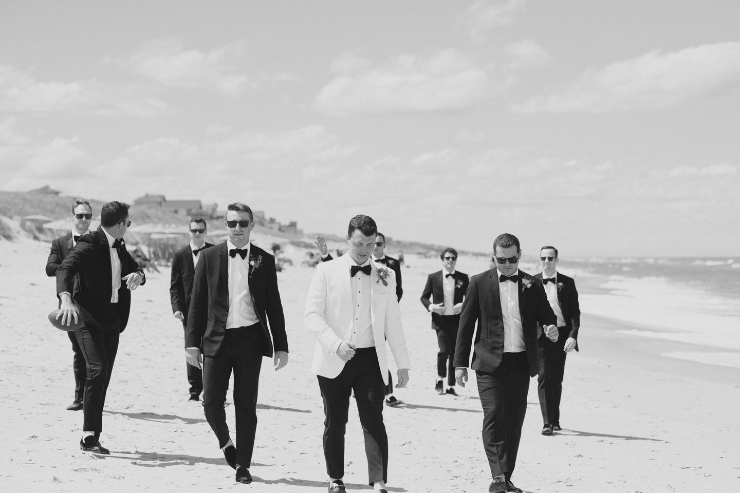 Groomsmen walking the beach on the Outer Banks
