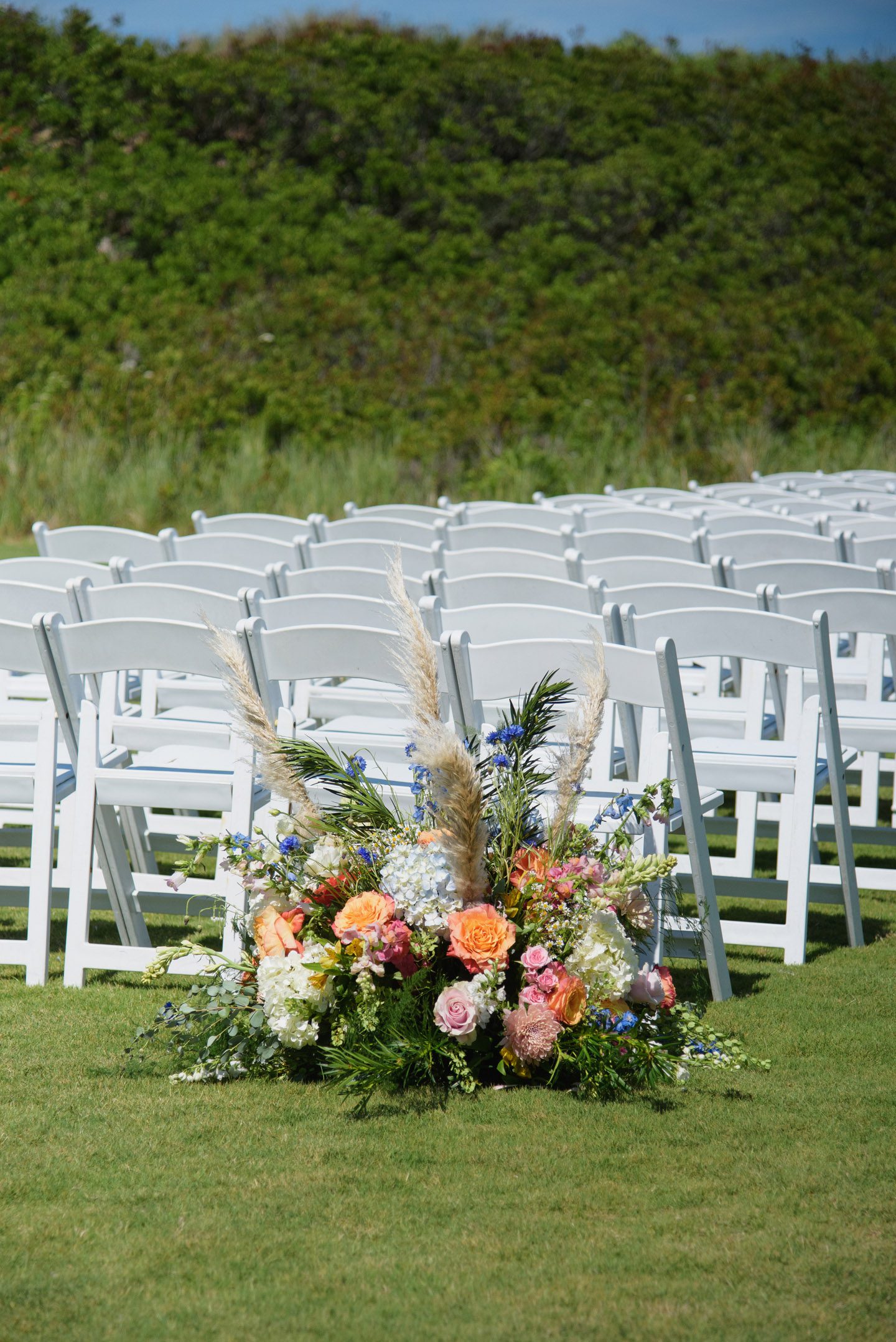 Wedding ceremony colorful spring florals at the Sanderling Resort