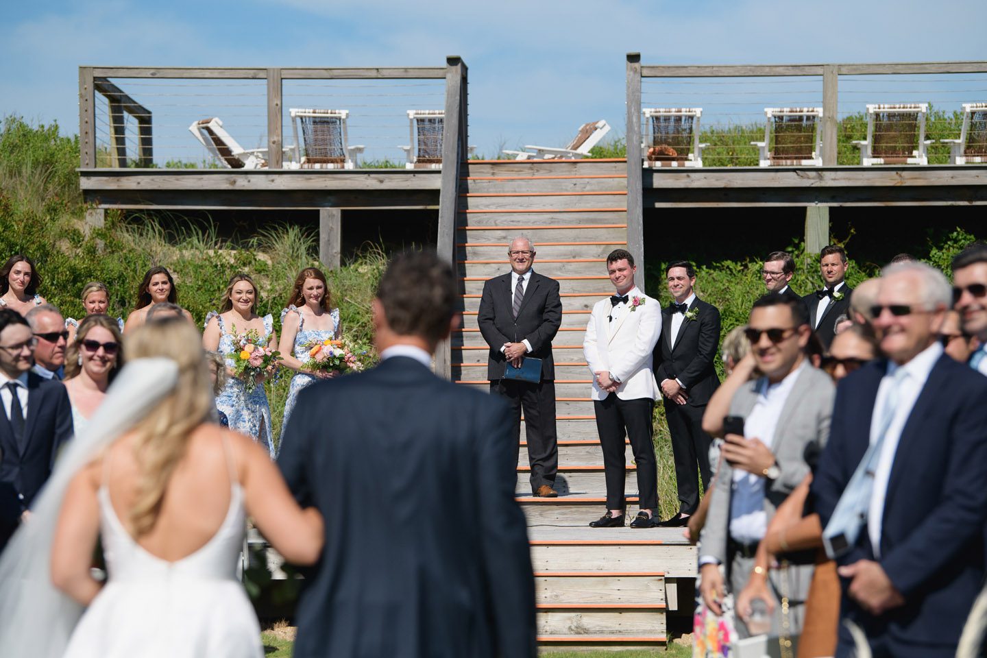 Groom looking on as the bride arrives at an Outer Banks wedding ceremony