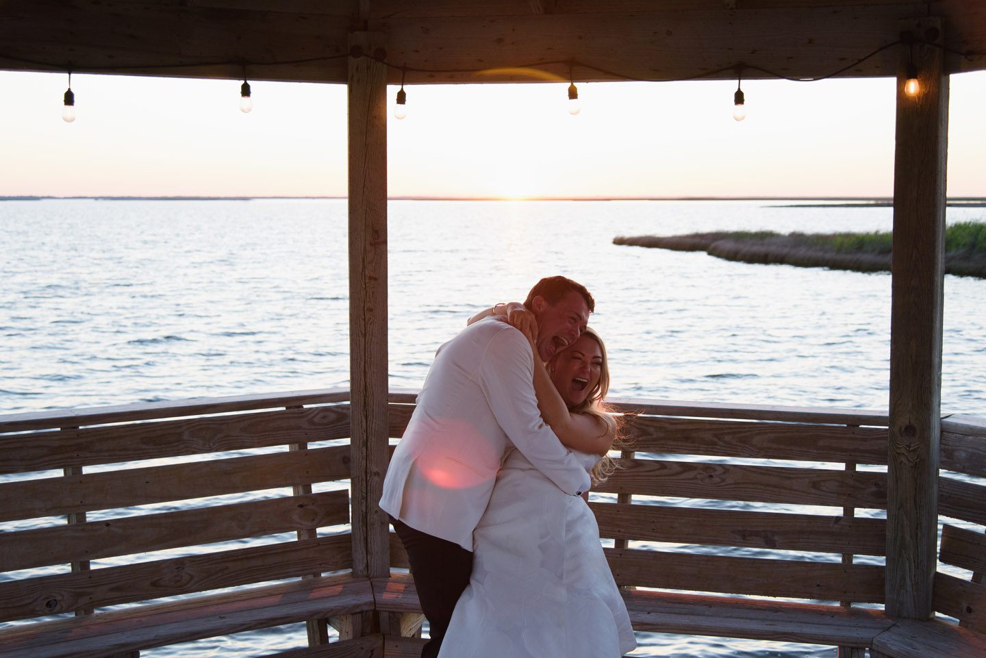 Bride and Groom laugh at sunset on the Outer Banks