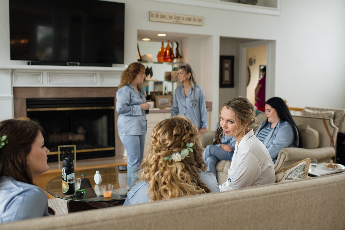 Bride and bridesmaids in matching pajamas getting ready for the wedding