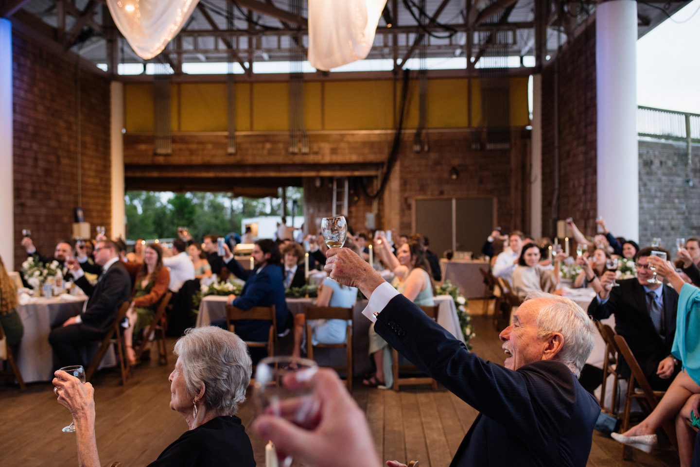 Wedding guests toast at Festival Park in Manteo